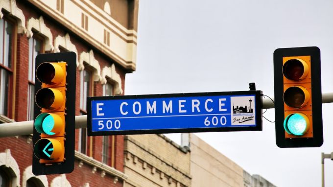 Ecommerce - a traffic light with a street sign hanging from it's side